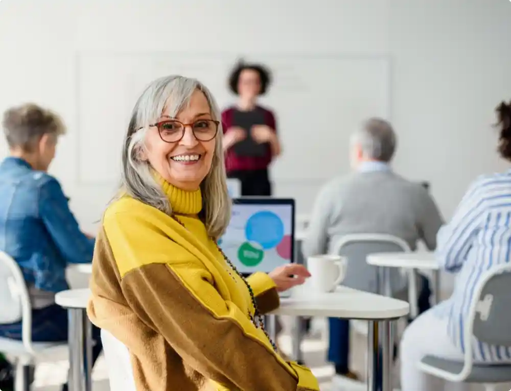 Woman using laptop in class